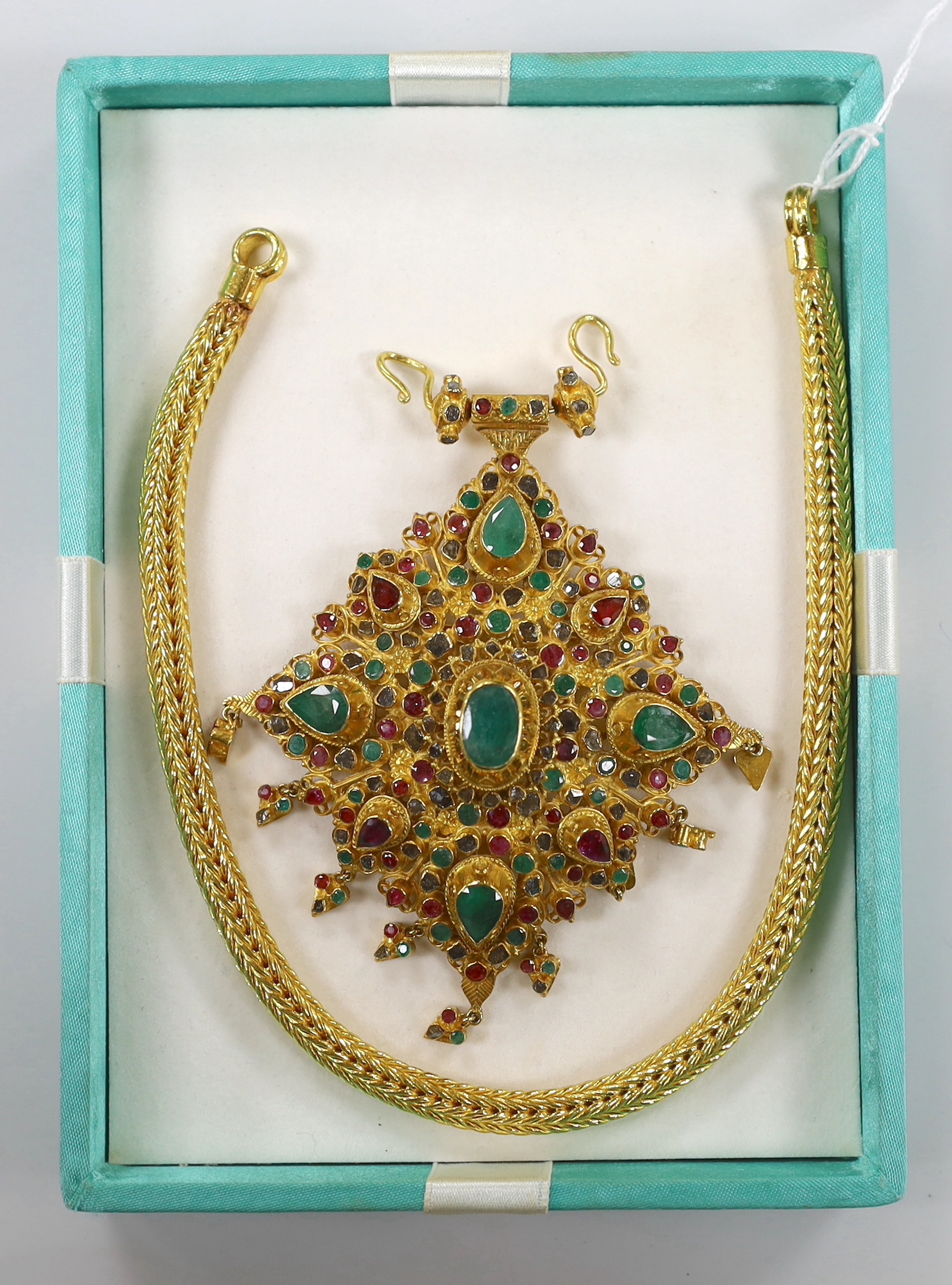 A 20th century Thai high grade yellow metal, ruby, emerald and rose cut diamond cluster set drop pendant, 95mm, on a high grade yellow metal interwoven chain, 34.5cm, gross 269.8 grams, with two spare clasp loops.